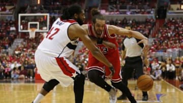 Apr 25, 2014; Washington, DC, USA; Chicago Bulls center Joakim Noah (13) dribbles the ball as Washington Wizards forward Nene (42) defends in the fourth quarter in game three of the first round of the 2014 NBA Playoffs at Verizon Center. The Bulls won 100-97. Mandatory Credit: Geoff Burke-USA TODAY Sports