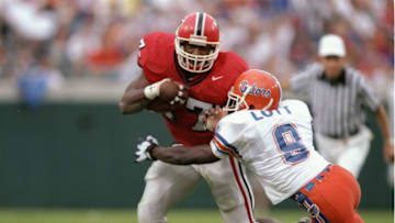 2 Nov 1996: Anthone Lott of the Florida Gators tries to tackle running back Robert Edwards of the Georgia Bulldogs during a game at Jacksonville Stadium in Jacksonville, Florida. Florida won the game 47-7. Mandatory Credit: Andy Lyons /Allsport