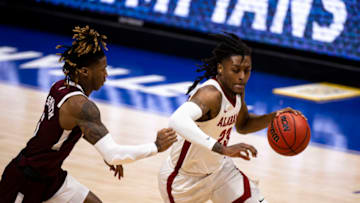 NASHVILLE, TN - MARCH 12: John Petty Jr. #23 of the Alabama Crimson Tide drives to the basket against Deivon Smith #5 of the Mississippi State Bulldogs during the second half of their quarterfinal game in the SEC Men's Basketball Tournament at Bridgestone Arena on March 12, 2021 in Nashville, Tennessee. Alabama defeats Mississippi State 85-48. (Photo by Brett Carlsen/Getty Images)