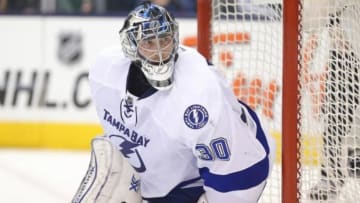 Mar 19, 2014; Toronto, Ontario, CAN; Tampa Bay Lightning goalie Ben Bishop (30) guards the net against the Toronto Maple Leafs at Air Canada Centre. The Lightning beat the Maple Leafs 5-3. Mandatory Credit: Tom Szczerbowski-USA TODAY Sports