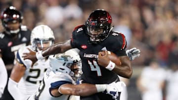 LOUISVILLE, KY - OCTOBER 05: Jawon Pass #4 of the Louisville Cardinals gets tackled while trying to pass by Desmond Branch #99 of the Georgia Tech Yellow Jackets in the first half of the game at Cardinal Stadium on October 5, 2018 in Louisville, Kentucky. (Photo by Joe Robbins/Getty Images)