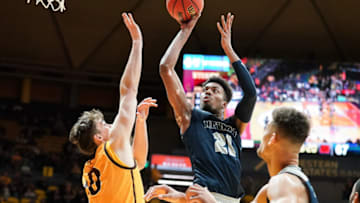 Feb 16, 2019; Laramie, WY, USA; Nevada Wolf Pack forward Jordan Brown (21) shoots against Wyoming Cowboys forward Hunter Thompson (10) during the second half at Arena-Auditorium. Mandatory Credit: Troy Babbitt-USA TODAY Sports