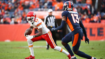 DENVER, COLORADO - JANUARY 08: Mecole Hardman #17 of the Kansas City Chiefs rushes ahead of Michael Ojemudia #13 of the Denver Broncos during the second half at Empower Field At Mile High on January 08, 2022 in Denver, Colorado. (Photo by Jamie Schwaberow/Getty Images)