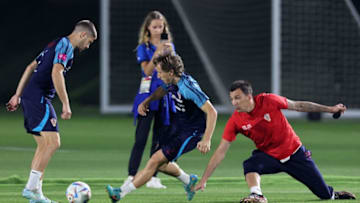 Luka Modric (C) and assistant coach Mario Mandzukic take part in a training session at the Al Erssal Training Site 3 in Doha on December 7, 2022, during the Qatar 2022 World Cup.(Photo by JACK GUEZ/AFP via Getty Images)