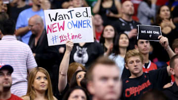 LOS ANGELES, CA - APRIL 29: Los Angeles Clippers hold up signs referencing the Donald Sterling situation before the game with the Golden State Warriors in Game Five of the Western Conference Quarterfinals during the 2014 NBA Playoffs at Staples Center on April 29, 2014 in Los Angeles, California. NOTE TO USER: User expressly acknowledges and agrees that, by downloading and or using this photograph, User is consenting to the terms and conditions of the Getty Images License Agreement. (Photo by Stephen Dunn/Getty Images)