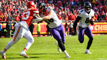 KANSAS CITY, MO - DECEMBER 9: Lamar Jackson #8 of the Baltimore Ravens runs behind the block of teammate Nick Boyle #86 during the second quarter of the game against the Kansas City Chiefs at Arrowhead Stadium on December 9, 2018 in Kansas City, Missouri. (Photo by Peter Aiken/Getty Images)