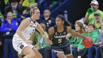 SOUTH BEND, IN - DECEMBER 02: Crystal Dangerfield #5 of the Connecticut Huskies dribbles the ball against Marina Mabrey #3 of the Notre Dame Fighting Irish at Purcell Pavilion on December 2, 2018 in South Bend, Indiana. (Photo by Michael Hickey/Getty Images)
