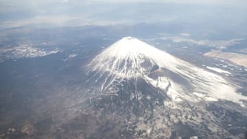 CHIBA, JAPAN - JANUARY 27 : An areal view of Fuji Mountain during a tour flight to Kagoshima, Japan on January 27, 2017. Japan Airlines 'wan wan jet tour' allows owners and their dogs to travel together on a charter flight for a special three-day domestic tour to Kagoshima Prefecture, southwestern Japan. As part of the package tour, the owners and their dogs will also get to stay together in a hotel and go sightseeing in rented cars. (Photo by Richard Atrero de Guzman/Anadolu Agency/Getty Images)