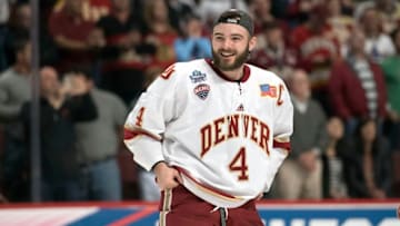 CHICAGO, IL - APRIL 08: Denver Pioneers defenseman Will Butcher (4) celebrates with teammates a victory against the Minnesota Duluth Bulldogs by raising the championship trophy after the 2017 NCAA Division I Men's Hockey Frozen Four Championship final at the United Center on April 8, 2017 in Chicago, Illinois. The Pioneers won the national championship 3-2. (Photo by Robin Alam/Icon Sportswire via Getty Images)