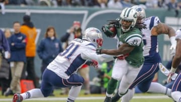 Dec 27, 2015; East Rutherford, NJ, USA; New York Jets running back Chris Ivory (33) breaks away from New England Patriots outside linebacker Jamie Collins (91) during the first quarter at MetLife Stadium. Mandatory Credit: Jim O