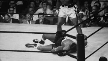 March 25, 1965 - Lewiston: Former boxing champ Sonny Liston lying on back atop canvas as legs of heavyweight champion Muhammad Ali looms over him after KO in first round of their rematch. (Photo by Mike Smith/Pix Inc./The LIFE Images Collection/Getty Images)