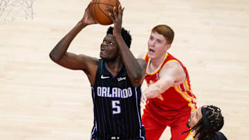 Apr 20, 2021; Atlanta, Georgia, USA; Orlando Magic center Mo Bamba (5) scores a basket behind Atlanta Hawks guard Kevin Huerter (3) during the first half at State Farm Arena. Mandatory Credit: Dale Zanine-USA TODAY Sports