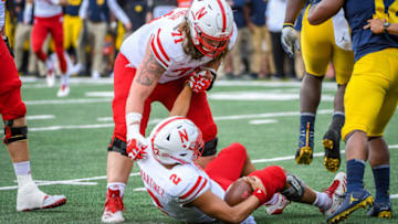 ANN ARBOR, MI - SEPTEMBER 22: Nebraska Cornhuskers offensive lineman Matt Farniok (71) helps Nebraska Cornhuskers quarterback Adrian Martinez (2) up after being sacked during the Michigan Wolverines versus Nebraska Cornhuskers game on Saturday September 22, 2018 at Michigan Stadium in Ann Arbor, MI. (Photo by Steven King/Icon Sportswire via Getty Images)