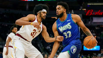 Dec 10, 2021; Minneapolis, Minnesota, USA; Minnesota Timberwolves center Karl-Anthony Towns (32) controls the ball as Cleveland Cavaliers center Jarrett Allen (31) defends during the first quarter at Target Center. Mandatory Credit: Nick Wosika-USA TODAY Sports