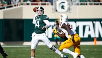 EAST LANSING, MI - SEPTEMBER 14: Brian Lewerke #14 of the Michigan State Spartans throws a pass while under pressure from Khaylan Kearse-Thomas #20 of the Arizona State Sun Devils in the first half of the game at Spartan Stadium on September 14, 2019 in East Lansing, Michigan. (Photo by Joe Robbins/Getty Images)