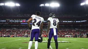 TAMPA, FL - OCTOBER 27: Marcus Peters #24 of the Baltimore Ravens talks with Lamar Jackson #8 on the sidelines during an NFL football game against the Tampa Bay Buccaneers at Raymond James Stadium on October 27, 2022 in Tampa, Florida. (Photo by Kevin Sabitus/Getty Images)