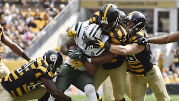 Oct 9, 2016; Pittsburgh, PA, USA; Pittsburgh Steelers outside linebacker Jarvis Jones (95) and other defenders make a tackle on New York Jets running back Matt Forte (22) during the first quarter at Heinz Field against the New York Jets. Mandatory Credit: Mark Konezny-USA TODAY Sports