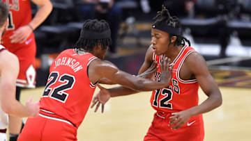 Oct 10, 2021; Cleveland, Ohio, USA; Chicago Bulls guard Ayo Dosunmu (12) celebrates his basket with forward Alize Johnson (22) in the fourth quarter against the Cleveland Cavaliers at Rocket Mortgage FieldHouse. Mandatory Credit: David Richard-USA TODAY Sports