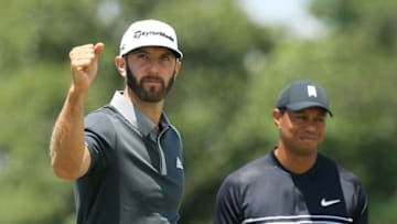 SOUTHAMPTON, NY - JUNE 15: Dustin Johnson of the United States celebrates making a birdie on the seventh hole as Tiger Woods of the United States looks on during the second round of the 2018 U.S. Open at Shinnecock Hills Golf Club on June 15, 2018 in Southampton, New York. (Photo by Mike Ehrmann/Getty Images)