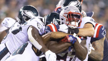 PHILADELPHIA, PA - AUGUST 19: Sony Michel #26 of the New England Patriots runs the ball and is tackled by Alex Singleton #49 of the Philadelphia Eagles in the first half of the preseason game at Lincoln Financial Field on August 19, 2021 in Philadelphia, Pennsylvania. The Patriots defeated the Eagles 35-0. (Photo by Mitchell Leff/Getty Images)