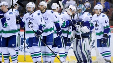 Feb 10, 2016; Glendale, AZ, USA; The Vancouver Canucks celebrate after beating the Arizona Coyotes 2-1 at Gila River Arena. Mandatory Credit: Matt Kartozian-USA TODAY Sports