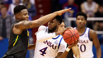 LAWRENCE, KANSAS - JANUARY 11: Isaiah Moss #4 of the Kansas Jayhawks controls the ball as Mark Vital #11 of the Baylor Bears defends during the game at Allen Fieldhouse on January 11, 2020 in Lawrence, Kansas. (Photo by Jamie Squire/Getty Images)
