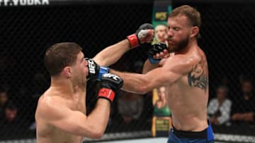 OTTAWA, ON - MAY 04: (R-L) Donald Cerrone punches Al Iaquinta in their lightweight bout during the UFC Fight Night event at Canadian Tire Centre on May 4, 2019 in Ottawa, Ontario, Canada. (Photo by Jeff Bottari/Zuffa LLC/Zuffa LLC via Getty Images)