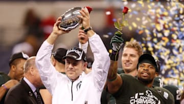 INDIANAPOLIS, IN - DECEMBER 07: Head coach Mark Dantonio of the Michigan State Spartans holds up the Big Ten championship trophy next to Denicos Allen #28 after defeating the Ohio State Buckeyes 34-24 at the Big 10 Conference Championship Game at Lucas Oil Stadium on December 7, 2013 in Indianapolis, Indiana. (Photo by Gregory Shamus/Getty Images)