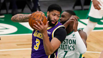 Jan 30, 2021; Boston, Massachusetts, USA; Los Angeles Lakers forward Anthony Davis (3) grabs a rebound from Boston Celtics guard Jaylen Brown (7) during the first quarter at TD Garden. Mandatory Credit: Winslow Townson-USA TODAY Sports