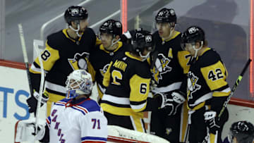 Mar 7, 2021; Pittsburgh, Pennsylvania, USA; The Pittsburgh Penguins celebrate a goal by center Evgeni Malkin (71) against New York Rangers goaltender Keith Kinkaid (71) during the third period at PPG Paints Arena. The Penguins won 5-1. Mandatory Credit: Charles LeClaire-USA TODAY Sports