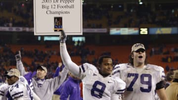 KANSAS CITY, MO - DECEMBER 6: Defensive back James McGill #8 and tackle Jon Doty #79 of the Kansas State Wildcats celebrate after defeating the Oklahoma Sooners in the Dr. Pepper Big 12 Championship on December 6, 2003 at Arrowhead Stadium in Kansas City, Missouri. Kansas State crushed Oklahoma 35-7. (Photo by Brian Bahr/Getty Images)