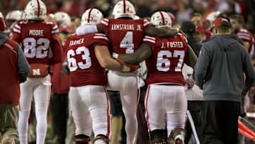 Nov 12, 2016; Lincoln, NE, USA; Nebraska Cornhuskers offensive lineman Tanner Farmer (63) and offensive lineman Jerald Foster (67) carry quarterback Tommy Armstrong Jr. (4) after Armstrong injured his leg scoring a touchdown against the Minnesota Golden Gophers in the second half at Memorial Stadium. Nebraska won 24-17. Mandatory Credit: Bruce Thorson-USA TODAY Sports