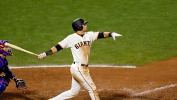 Oct 10, 2016; San Francisco, CA, USA; San Francisco Giants second baseman Joe Panik (12) hits a walk-off RBI double against the Chicago Cubs during the thirteenth inning during game three of the 2016 NLDS playoff baseball series at AT&T Park. The San Francisco Giants won 6-5 in thirteen innings. Mandatory Credit: John Hefti-USA TODAY Sports