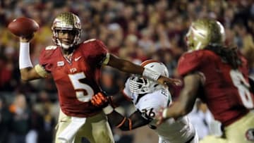 Nov 2, 2013; Tallahassee, FL, USA; Florida State Seminoles quarterback Jameis Winston (5) evades Miami Hurricanes linebacker Alex Figueroa (36) as he throws the ball during the second half at Doak Campbell Stadium. Mandatory Credit: Melina Vastola-USA TODAY Sports