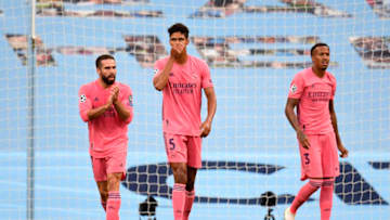 MANCHESTER, ENGLAND - AUGUST 07: Raphael Varane of Real Madrid looks dejected after his team concede during the UEFA Champions League round of 16 second leg match between Manchester City and Real Madrid at Etihad Stadium on August 07, 2020 in Manchester, England. (Photo by Peter Powell/Pool via Getty Images)