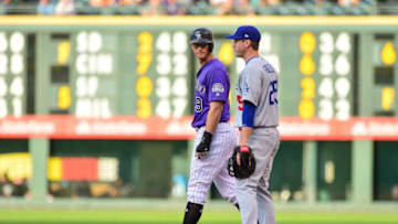 DENVER, CO - SEPTEMBER 8: DJ LeMahieu #9 of the Colorado Rockies stands at first base with David Freese #25 of the Los Angeles Dodgers after hitting his 1,000th career hit on an infield single during a game at Coors Field on September 8, 2018 in Denver, Colorado. (Photo by Dustin Bradford/Getty Images)