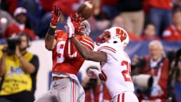 Dec 6, 2014; Indianapolis, IN, USA; Ohio State Buckeyes wide receiver Devin Smith (9) catches a pass in the end zone for a touchdown against Wisconsin Badgers cornerback Terrance Floyd (29) during the Big Ten football championship game at Lucas Oil Stadium. Mandatory Credit: Brian Spurlock-USA TODAY Sports