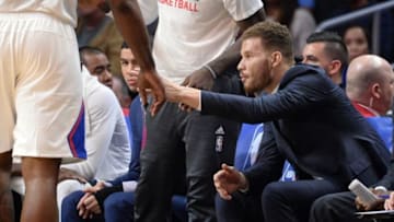 Feb 18, 2016; Los Angeles, CA, USA; Injured forward Blake Griffin greets teammate Los Angeles Clippers center DeAndre Jordan (6) as he walks to the bench during the 1st half against the San Antonio Spurs at Staples Center. Mandatory Credit: Robert Hanashiro-USA TODAY Sports