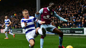 LONDON, ENGLAND - DECEMBER 18: Albert Adomah of Aston Villa holds off Jake Bidwell of Queens Park Rangers during the Sky Bet Championship match between Queens Park Rangers and Aston Villa at Loftus Road on December 18, 2016 in London, England. (Photo by Dan Mullan/Getty Images)