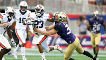 Auburn footballSep 1, 2018; Atlanta, GA, USA; Auburn Tigers punt returner Ryan Davis (23) is tackled by Washington Huskies punter Joel Whitford (32) in the first quarter at Mercedes-Benz Stadium. Mandatory Credit: Brett Davis-USA TODAY Sports