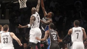 Apr 13, 2014; Brooklyn, NY, USA; Brooklyn Nets forward Kevin Garnett (2) blocks a shot against Orlando Magic center Dewayne Dedmon (3) in the fourth quarter at Barclays Center. Nets win 97-88. Mandatory Credit: Nicole Sweet-USA TODAY Sports