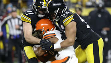 Jan 3, 2022; Pittsburgh, Pennsylvania, USA; Pittsburgh Steelers inside linebacker Robert Spillane (41) and outside linebacker Alex Highsmith (56) tackle Cleveland Browns running back Nick Chubb (24) during the first quarter at Heinz Field. Mandatory Credit: Charles LeClaire-USA TODAY Sports