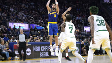 SAN FRANCISCO, CALIFORNIA - DECEMBER 10: Klay Thompson #11 of the Golden State Warriors shoots and scores over Jaylen Brown #7 and Jayson Tatum #0 of the Boston Celtics during the second quarter of an NBA basketball game at Chase Center on December 10, 2022 in San Francisco, California. NOTE TO USER: User expressly acknowledges and agrees that, by downloading and or using this photograph, User is consenting to the terms and conditions of the Getty Images License Agreement. (Photo by Thearon W. Henderson/Getty Images)