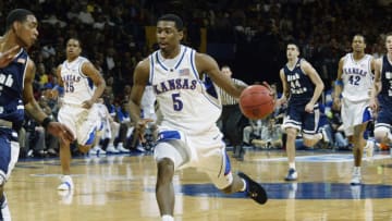 OKLAHOMA CITY, OK - MARCH 20: Guard Keith Langford #5 of the Kansas Jayhawks moves the ball past Cardell Butler #15 of the Utah State Aggies during the first round of the NCAA Tournament at the Ford Center March 20, 2003, in Oklahoma City, OK. The Jayhawks defeated the Aggies 64-61. (Photo by Ronald Martinez/Getty Images)