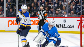 WINNIPEG, MB - FEBRUARY 1: Jaden Schwartz #17 of the St. Louis Blues watches as the puck slides wide of goaltender Connor Hellebuyck #37 of the Winnipeg Jets during third period action at the Bell MTS Place on February 1, 2020 in Winnipeg, Manitoba, Canada. The Jets defeated the Blues 5-2. (Photo by Jonathan Kozub/NHLI via Getty Images)