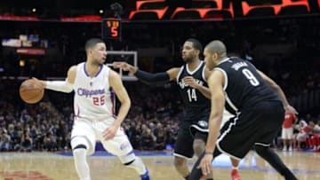 Jan 22, 2015; Los Angeles, CA, USA; Los Angeles Clippers guard Austin Rivers (25) controls the ball against Brooklyn Nets guard Darius Morris (14) and center Jerome Jordan (9) during the second half at Staples Center. Mandatory Credit: Richard Mackson-USA TODAY Sports