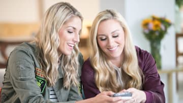 Elena Delle Donne and Amanda Clifton smile while looking at wedding rings. Credit: Sara Wight Photography