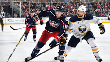 COLUMBUS, OH - OCTOBER 27: Pierre-Luc Dubois #18 of the Columbus Blue Jackets skates for the puck against Marco Scandella #6 of the Buffalo Sabres in the third period on October 27, 2018 at Nationwide Arena in Columbus, Ohio. (Photo by Jamie Sabau/NHLI via Getty Images)