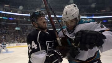 May 23, 2013; Los Angeles, CA, USA; Los Angeles Kings center Coliln Fraser (24) checks San Jose Sharks defenseman Brad Stuart (7) into the boards in game five of the second round of the 2013 Stanley Cup Playoffs at the Staples Center. The Kings defeated the Sharks to take a 3-2 series lead. Mandatory Credit: Kirby Lee-USA TODAY Sports