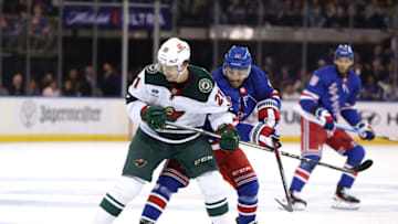 NEW YORK, NEW YORK - NOVEMBER 09: Brandon Duhaime #21 of the Minnesota Wild and Vincent Trocheck #16 of the New York Rangers fight for the puck during the second period at Madison Square Garden on November 09, 2023 in New York City. (Photo by Elsa/Getty Images)